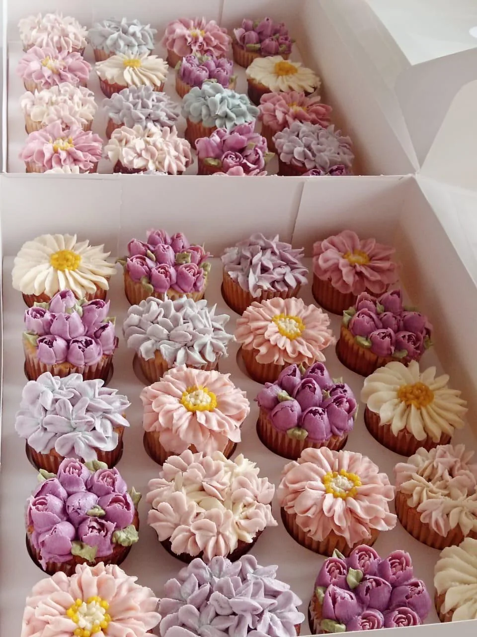 Boxes of floral buttercream cupcakes by Fig & Owl, made for corporate gifting
