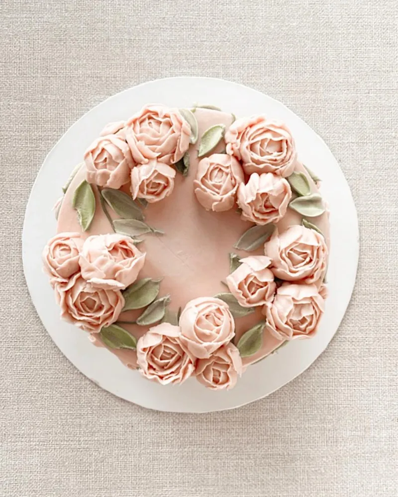 A buttercream rose wreath Bloom cake