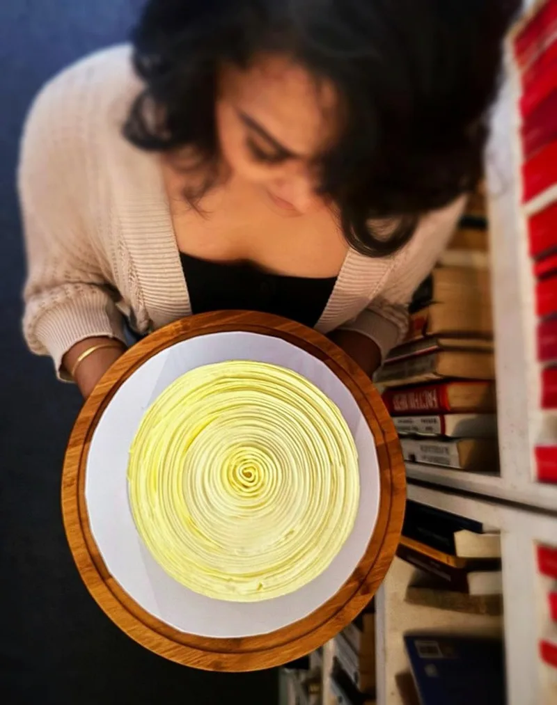 Hand-piping a cake on the turntable at Fig & Owl