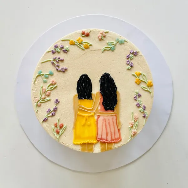 A painted portrait framed with buttercream flowers
